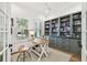 Bright office with a built-in bookshelf, wood desk, and natural light from shuttered windows at 2604 W Jetton Ave, Tampa, FL 33629