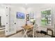 Modern office featuring a wood desk, television, white trim, and a large shuttered window at 2604 W Jetton Ave, Tampa, FL 33629