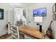Bright home office featuring a wood desk, television, and views through french doors at 2604 W Jetton Ave, Tampa, FL 33629