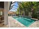 Screened-in pool with waterfall feature, lounge seating and lush, tropical foliage at 2604 W Jetton Ave, Tampa, FL 33629
