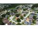Community aerial view showcases diverse homes, green spaces, and a serene pond surrounded by mature trees at 28826 Windover St, Wesley Chapel, FL 33545