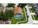 Aerial view of home with a screened pool, fenced yard, and mature landscaping in a well-kept neighborhood at 28826 Windover St, Wesley Chapel, FL 33545