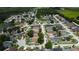 Panoramic aerial view of a neighborhood with winding streets, lush trees, and varied home designs at 28826 Windover St, Wesley Chapel, FL 33545