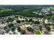 Aerial view of a large residential area with lush green spaces, various roof styles, and well-maintained lawns at 28826 Windover St, Wesley Chapel, FL 33545