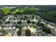 Aerial view of a residential neighborhood with lush green spaces, various roof styles, and well-maintained lawns at 28826 Windover St, Wesley Chapel, FL 33545