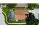 Aerial view of backyard featuring an enclosed pool, well-maintained lawn, and mature trees at 28826 Windover St, Wesley Chapel, FL 33545