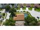 Aerial view of home with a screened pool, fenced yard, and mature landscaping in a well-kept neighborhood at 28826 Windover St, Wesley Chapel, FL 33545