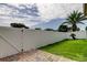 Fenced backyard features lush lawn, mature landscaping and a brick paver patio leading to a home at 28826 Windover St, Wesley Chapel, FL 33545