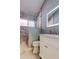 Modern bathroom with a marble-tiled shower and a stylish vanity with a lighted mirror at 28826 Windover St, Wesley Chapel, FL 33545