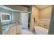 Modern bathroom featuring dual sinks, walk-in shower, and soaking tub at 28826 Windover St, Wesley Chapel, FL 33545