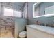 Beautiful bathroom features marble tiled shower, updated vanity and sink with modern mirror at 28826 Windover St, Wesley Chapel, FL 33545