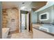 Bright bathroom boasts marble floors, tiled shower, freestanding tub, and modern light-up mirror at 28826 Windover St, Wesley Chapel, FL 33545