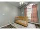 A bright Bedroom featuring a window with pink curtains and a ceiling fan at 28826 Windover St, Wesley Chapel, FL 33545