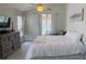 Bright bedroom with ceiling fan, dresser, and slider to the outside patio at 28826 Windover St, Wesley Chapel, FL 33545
