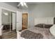 Cozy bedroom features a ceiling fan, sliding mirrored closet doors and an entrance to a bathroom at 28826 Windover St, Wesley Chapel, FL 33545