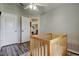 Bedroom with wood-look laminate flooring, baby bed, and white doors at 28826 Windover St, Wesley Chapel, FL 33545