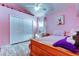 Bright pink bedroom featuring decor, large closet, and wood-look laminate flooring at 28826 Windover St, Wesley Chapel, FL 33545