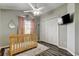 Bright Bedroom includes closet, ceiling fan, window, and wood-look floors at 28826 Windover St, Wesley Chapel, FL 33545