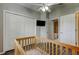 Bedroom featuring a baby bed, closet, ceiling fan and a door to the bathroom at 28826 Windover St, Wesley Chapel, FL 33545