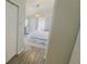 Bedroom with light wood floors, white curtains and door to pool area at 28826 Windover St, Wesley Chapel, FL 33545