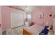 Pink bedroom featuring a bed, closet, make up desk, and bright decorations at 28826 Windover St, Wesley Chapel, FL 33545