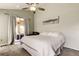 Light-filled bedroom with ceiling fan and sliding glass doors to an outdoor living space at 28826 Windover St, Wesley Chapel, FL 33545