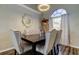 Formal dining room featuring modern light fixture and neutral finishes at 28826 Windover St, Wesley Chapel, FL 33545