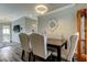 Elegant dining room featuring a chandelier, mirror, and tufted chairs for a sophisticated dining experience at 28826 Windover St, Wesley Chapel, FL 33545