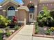 Well-maintained front yard with inviting walkway leading to the front door with decorative wreath at 28826 Windover St, Wesley Chapel, FL 33545