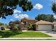 Beautiful single-story home with a manicured lawn, arched windows, and a two-car garage at 28826 Windover St, Wesley Chapel, FL 33545