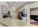 Spacious kitchen with gray cabinets and stainless appliances, adjacent to the living room at 28826 Windover St, Wesley Chapel, FL 33545