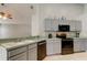 Bright kitchen with gray cabinets, stainless steel appliances, and plenty of counter space at 28826 Windover St, Wesley Chapel, FL 33545