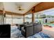 Cozy lanai offers comfortable seating, ceiling fans, and views of the private backyard at 28826 Windover St, Wesley Chapel, FL 33545
