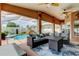 Inviting lanai boasts comfortable seating with views of the sparkling pool and lush landscaping at 28826 Windover St, Wesley Chapel, FL 33545