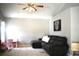 Cozy living room with a ceiling fan, plush grey sofa, and bright natural light at 28826 Windover St, Wesley Chapel, FL 33545