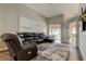 Comfortable living room with large sectional, and sliding door access to pool at 28826 Windover St, Wesley Chapel, FL 33545