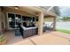 Relaxing covered patio featuring comfortable seating and a ceiling fan at 28826 Windover St, Wesley Chapel, FL 33545