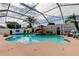 Sparkling pool featuring a rock waterfall, surrounded by lush plants and a screened enclosure at 28826 Windover St, Wesley Chapel, FL 33545
