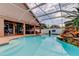 Backyard pool with a rock waterfall feature, ideal for relaxation and entertainment at 28826 Windover St, Wesley Chapel, FL 33545