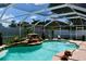 Inviting pool with rock waterfall feature and a screened enclosure at 28826 Windover St, Wesley Chapel, FL 33545