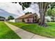 Well-maintained home featuring a green lawn, sidewalk, and privacy fence at 28826 Windover St, Wesley Chapel, FL 33545
