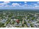 Get a birds eye view of this homes location surrounded by lush greenery under a beautiful sky at 2910 11Th N St, St Petersburg, FL 33704