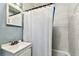 Bathroom showcasing a shower with white tiling, a basin, and blue walls at 3315 58Th S Ave # 311, St Petersburg, FL 33712