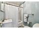 Cozy bathroom with tiled walls, a bathtub with shower curtain, and storage for towels at 3315 58Th S Ave # 311, St Petersburg, FL 33712