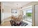 Bright dining area features modern light fixture, neutral decor, sliding glass door to balcony with outdoor seating at 3315 58Th S Ave # 311, St Petersburg, FL 33712