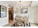Dining room has a modern light fixture, a table set for four and overlooks an adjacent kitchen at 3315 58Th S Ave # 311, St Petersburg, FL 33712