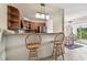 Eat in kitchen with wood cabinets, breakfast bar, stainless steel appliances, open to dining area with balcony at 3315 58Th S Ave # 311, St Petersburg, FL 33712