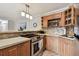 Cozy eat-in kitchen with wood cabinets, stainless steel oven, and breakfast bar open to dining area at 3315 58Th S Ave # 311, St Petersburg, FL 33712