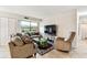 Inviting living room with comfortable seating, large windows, tile floors, and bright natural light at 3315 58Th S Ave # 311, St Petersburg, FL 33712