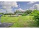 Lush green backyard with barn, small trees, and solar panel, showing outdoor living and space at 3505 Medulla Rd, Plant City, FL 33566